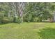 Green backyard with mature trees and shade at 62 Sunny Ln, Villa Rica, GA 30180