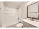 Bright bathroom featuring a shower-tub combo with white tile surround and modern vanity at 62 Sunny Ln, Villa Rica, GA 30180