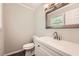 Updated half bathroom with modern vanity, stylish mirror, and hardwood floors at 62 Sunny Ln, Villa Rica, GA 30180
