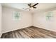 A bright bedroom featuring hardwood floors, neutral walls, and a ceiling fan at 62 Sunny Ln, Villa Rica, GA 30180