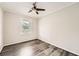 Cozy bedroom featuring hardwood floors, neutral walls, and a ceiling fan at 62 Sunny Ln, Villa Rica, GA 30180