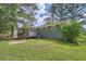 Back of house with a large green yard, a screened in porch and a deck at 62 Sunny Ln, Villa Rica, GA 30180