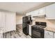 This kitchen features modern black appliances, white cabinets and granite countertops at 62 Sunny Ln, Villa Rica, GA 30180