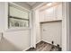 Practical laundry room features cabinetry and vinyl floors and a window at 62 Sunny Ln, Villa Rica, GA 30180