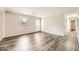 A bright living area with light gray walls, contemporary gray wood-look floors, and a view of the backyard at 62 Sunny Ln, Villa Rica, GA 30180