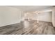 Spacious living room with light gray walls and stylish gray wood-look floors, with plenty of room to relax at 62 Sunny Ln, Villa Rica, GA 30180