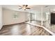 Spacious living room featuring gray wood-look floors, light gray walls, and large windows for plenty of sunlight at 62 Sunny Ln, Villa Rica, GA 30180