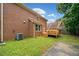 A brick home featuring a wooden deck in a green backyard at 1237 Hunters Dr, Stone Mountain, GA 30083