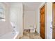 Cozy bathroom featuring a bathtub and shower combination, along with a wooden door at 1237 Hunters Dr, Stone Mountain, GA 30083