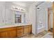 A charming bathroom featuring a double sink vanity and a separate tub with tiled walls at 1237 Hunters Dr, Stone Mountain, GA 30083