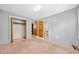 Bedroom with a walk-in closet, ensuite bath, neutral paint, and plush carpeting at 1237 Hunters Dr, Stone Mountain, GA 30083