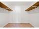 A bright walk-in closet featuring two wooden shelves and neutral carpeting at 1237 Hunters Dr, Stone Mountain, GA 30083