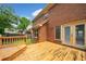 Wood deck attached to a brick home with a door to the interior at 1237 Hunters Dr, Stone Mountain, GA 30083