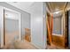 Hallway featuring stair railing and doorways, painted neutral colors, and plush carpeting at 1237 Hunters Dr, Stone Mountain, GA 30083