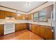 Charming kitchen featuring wood cabinets and a stainless steel dishwasher at 1237 Hunters Dr, Stone Mountain, GA 30083