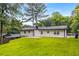 Charming one-story home with lush green lawn and landscaping in the backyard at 3536 Redwine Ct, Atlanta, GA 30344