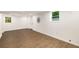 Finished basement with wood-look floors, white walls, and natural light from two windows at 3536 Redwine Ct, Atlanta, GA 30344