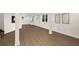 This basement area is finished with wood-look floors, white walls, and recessed lighting at 3536 Redwine Ct, Atlanta, GA 30344
