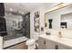 Bathroom showcases a glass-enclosed shower with mosaic tile and modern vanity with gold fixtures at 3536 Redwine Ct, Atlanta, GA 30344