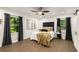 Primary bedroom with hardwood floors, ceiling fan, barn doors, and plenty of natural light at 3536 Redwine Ct, Atlanta, GA 30344