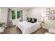 Bright bedroom with decorative pillows, modern accents, and a large window showing outside greenery at 3536 Redwine Ct, Atlanta, GA 30344