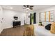 Bright bedroom features a ceiling fan, wood-look floors, and a stylish accent wall with decor at 3536 Redwine Ct, Atlanta, GA 30344