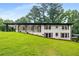 Charming home with a covered porch and well-manicured lawn, surrounded by mature trees at 3536 Redwine Ct, Atlanta, GA 30344