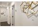Hallway with stylish geometric gold decorations and dark floors leading to other rooms at 3536 Redwine Ct, Atlanta, GA 30344