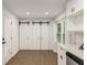 Bright kitchen features white cabinets, marble countertops, and modern barn doors for extra storage at 3536 Redwine Ct, Atlanta, GA 30344