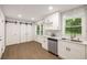 Bright kitchen with white cabinets, stainless steel appliances, and a view of the backyard at 3536 Redwine Ct, Atlanta, GA 30344
