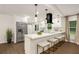Modern kitchen boasts stainless steel appliances, a center island with seating, and stylish pendant lighting at 3536 Redwine Ct, Atlanta, GA 30344