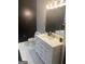 Bathroom featuring a white vanity, hexagon tile floors, and black accent wall at 870 Mayson Turner Nw Rd # 1102, Atlanta, GA 30314