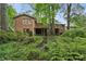 Beautiful backyard with mature trees, lush landscaping, and a deck, perfect for outdoor living at 1215 Vista Leaf Dr, Decatur, GA 30033
