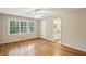Bright bedroom featuring hardwood floors, a ceiling fan, and a view into the ensuite bathroom at 1215 Vista Leaf Dr, Decatur, GA 30033