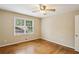 Bedroom with hardwood floors and a large window offering natural light at 1215 Vista Leaf Dr, Decatur, GA 30033