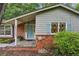 Welcoming front entry with brick accents, light blue door, and cozy porch at 1215 Vista Leaf Dr, Decatur, GA 30033