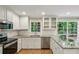 Bright kitchen boasts granite countertops, stainless steel appliances, and white cabinets with natural outdoor views at 1215 Vista Leaf Dr, Decatur, GA 30033