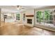 Bright living room with fireplace, wood floors, and large windows to the backyard deck at 1215 Vista Leaf Dr, Decatur, GA 30033