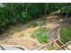 An aerial view of the backyard featuring a cozy fire pit area and lush, mature trees at 2637 Morningside Nw Trl, Kennesaw, GA 30144