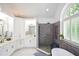 Bathroom features dual vanities, tiled shower, soaking tub and arched window at 2637 Morningside Nw Trl, Kennesaw, GA 30144
