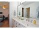 Bathroom featuring a double sink vanity, modern fixtures, and access to an adjoining room at 2637 Morningside Nw Trl, Kennesaw, GA 30144