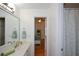 Bright bathroom featuring a single sink vanity, a large mirror, and a shower with a curtain at 2637 Morningside Nw Trl, Kennesaw, GA 30144