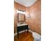 Charming powder room with floral wallpaper, vanity, and updated fixtures at 2637 Morningside Nw Trl, Kennesaw, GA 30144