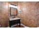 Charming powder room with floral wallpaper, vanity, and updated fixtures at 2637 Morningside Nw Trl, Kennesaw, GA 30144