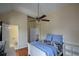 Bedroom with attached bath, desk, built-in shelving, and a ceiling fan at 2637 Morningside Nw Trl, Kennesaw, GA 30144