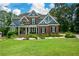 Stunning two-story brick home with a manicured lawn and inviting front porch with stately columns at 2637 Morningside Nw Trl, Kennesaw, GA 30144