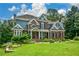Charming two-story home featuring a lush green lawn and beautifully landscaped front yard at 2637 Morningside Nw Trl, Kennesaw, GA 30144