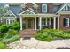 Charming brick home featuring a covered front entrance with columns and well-manicured landscaping at 2637 Morningside Nw Trl, Kennesaw, GA 30144