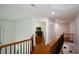 Upstairs hallway with hardwood floors and access to bedrooms, offering a bright and open feel at 2637 Morningside Nw Trl, Kennesaw, GA 30144