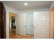 Hallway with wood floor and access to a large closet and other rooms at 2637 Morningside Nw Trl, Kennesaw, GA 30144